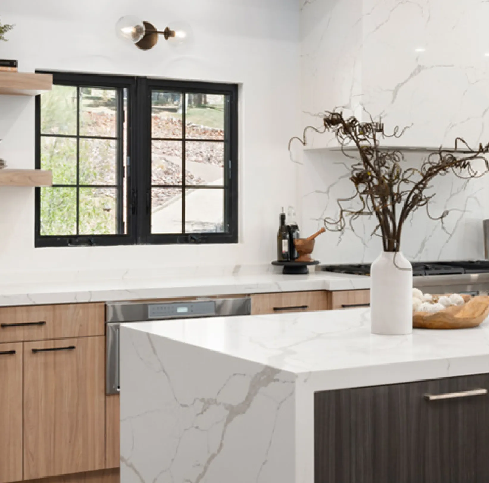 msi-q-1 White marble countertop with blurred modern bathroom in the background, including a window and green plant.